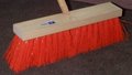 Orange street broom 18 inches wide with 5 inch stiff trim set in a hardwood block